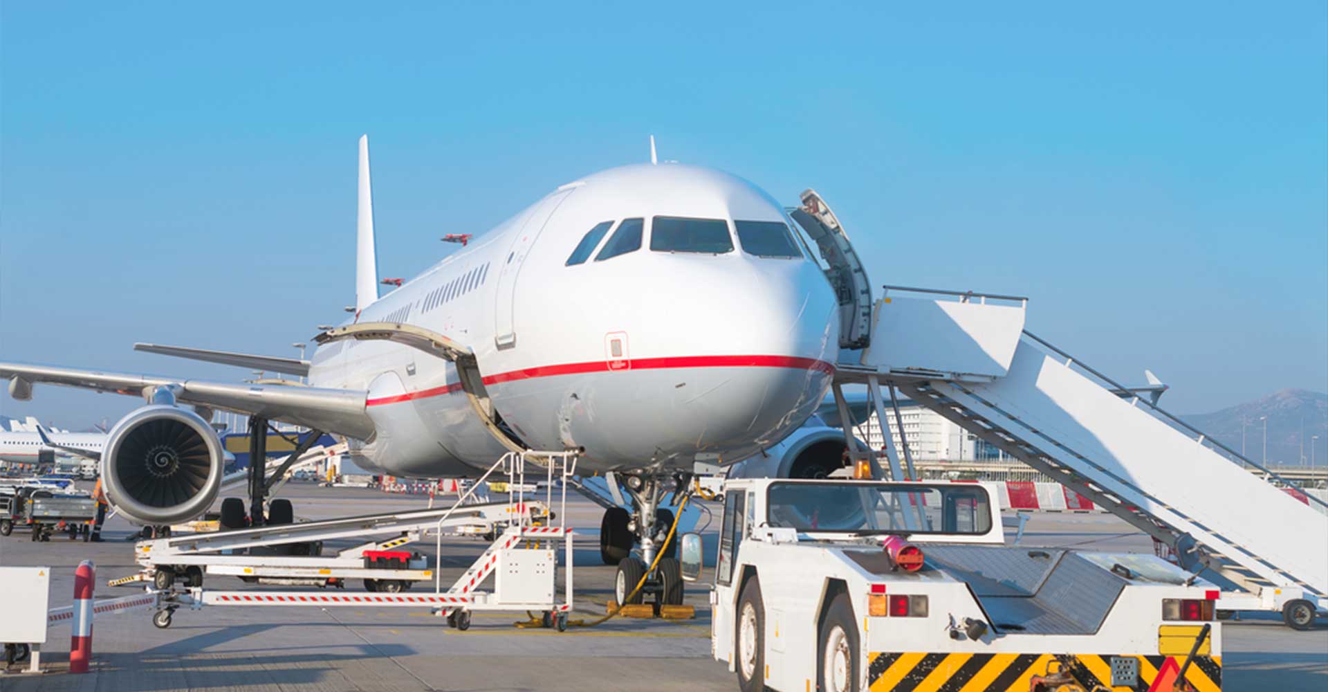 Airport ground crew managing logistics around a private jet